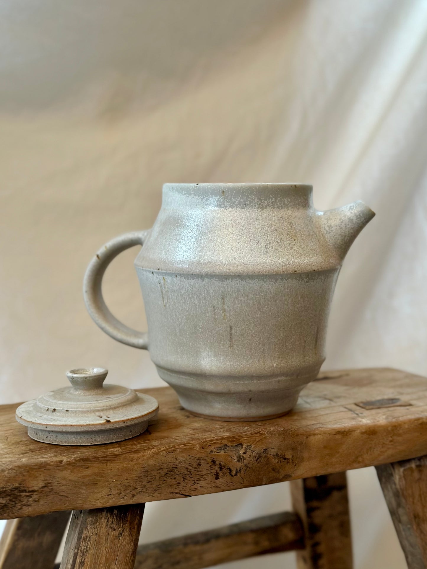 Antique white revolve teapot